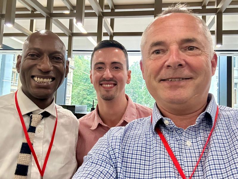 Simon Long with two colleagues, smiling
