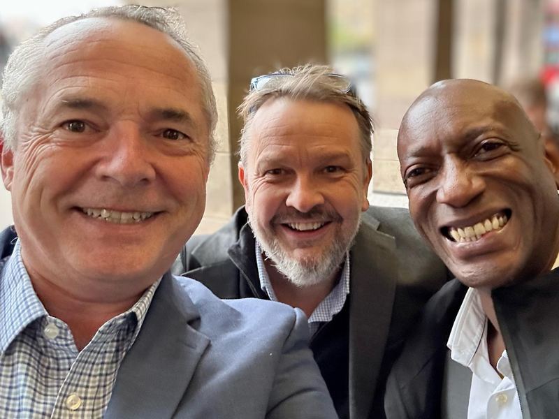 Simon Long with two colleagues at an event